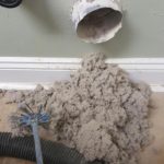 Pile of dryer lint removed from vent duct with rotary brush tool