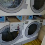 Bank of commercial laundry dryers.